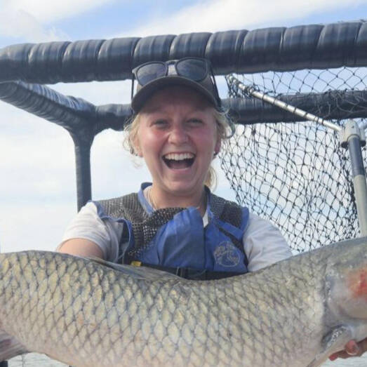 Bridgette Gorg holds a large fish.